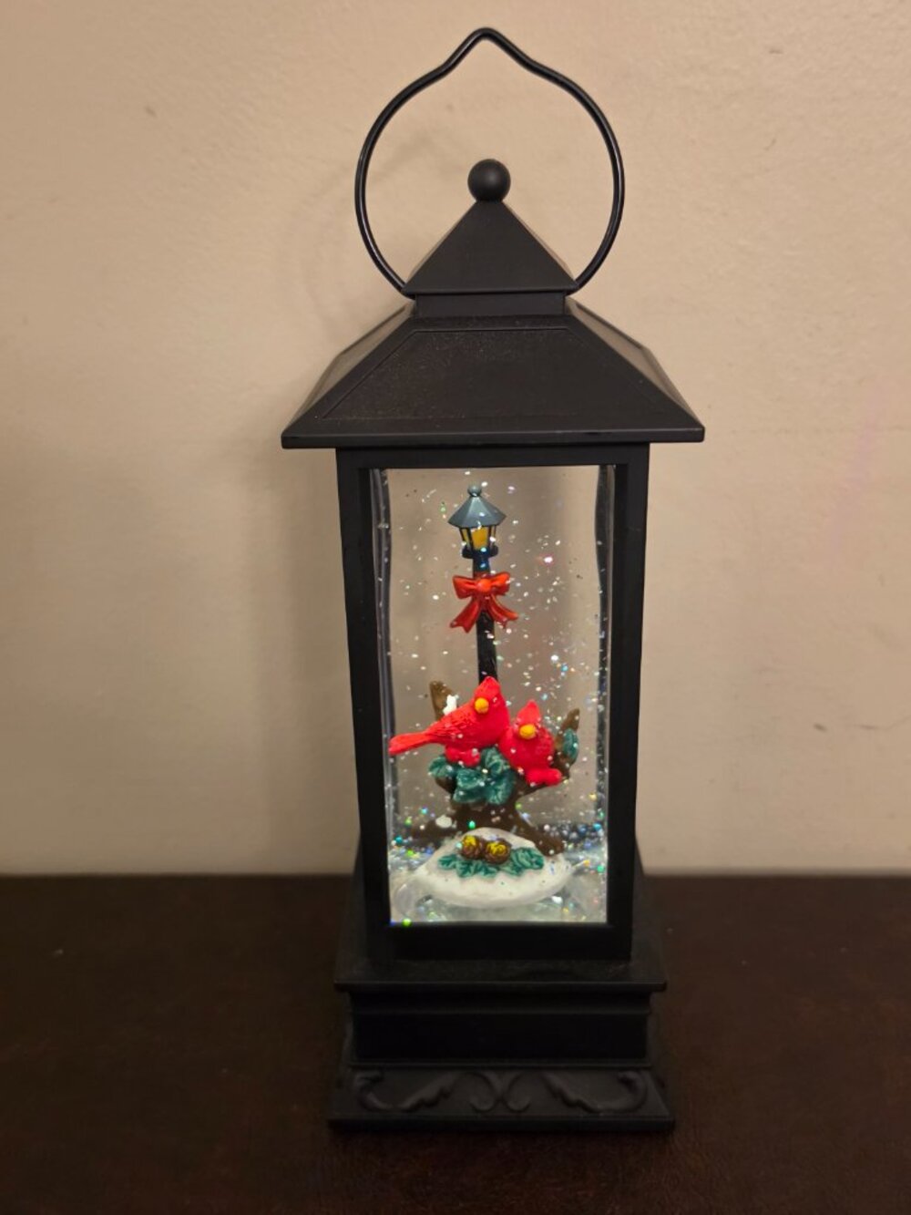 Black Cardinal Snow Globe Lantern is a traditional style LED lighting decoration